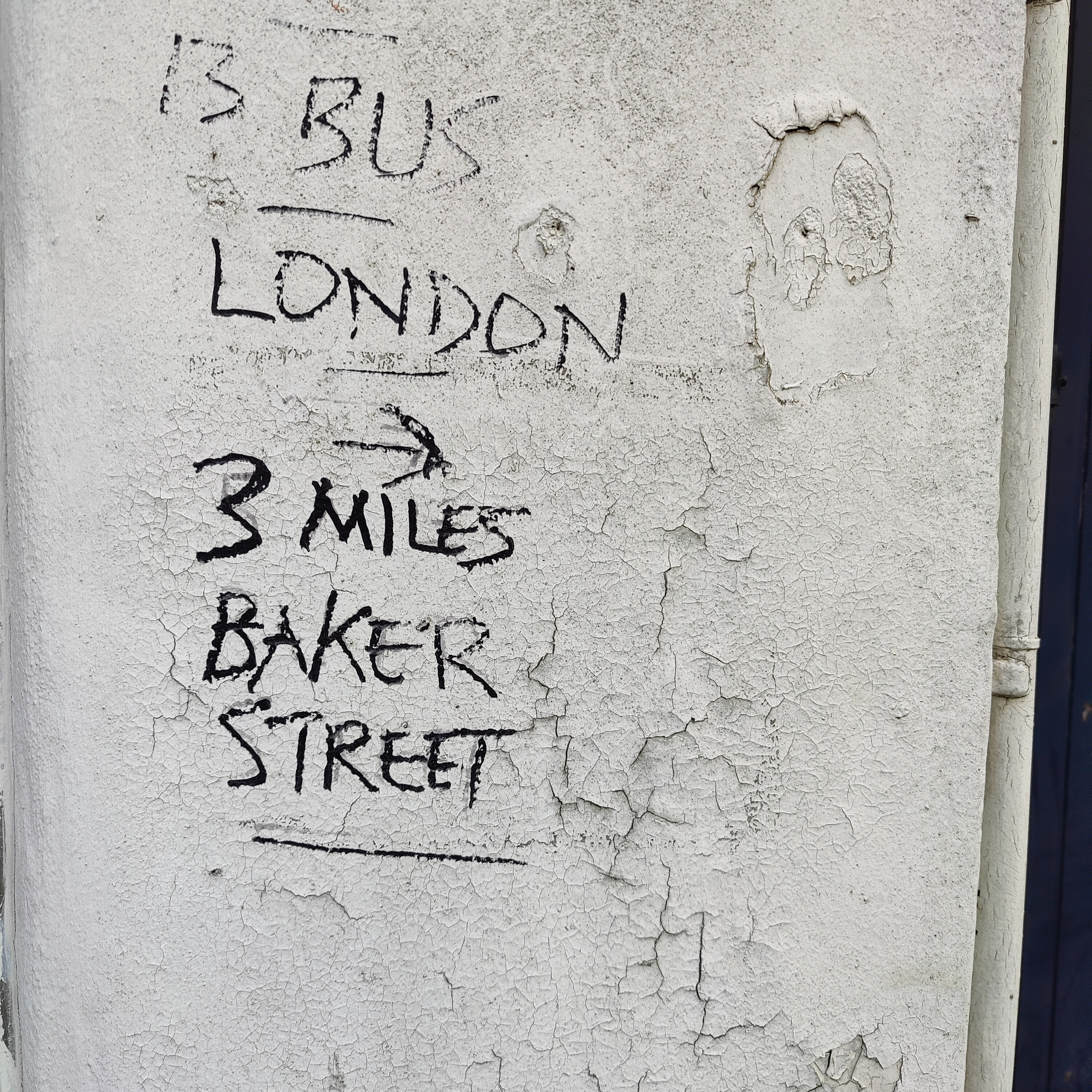 Writing on a shop wall, Finchley Road